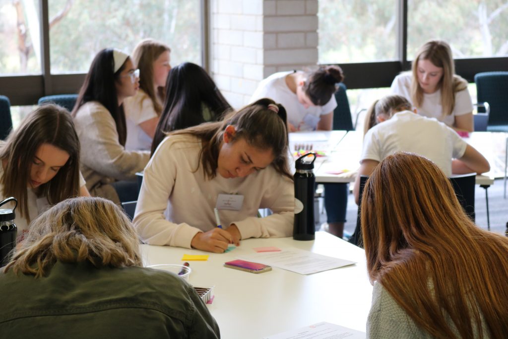 Girls writing in workshop