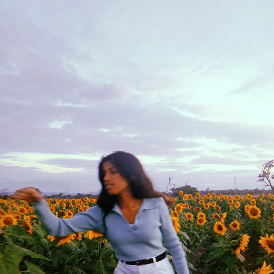 Angela Paulson stands in a sunflower field.